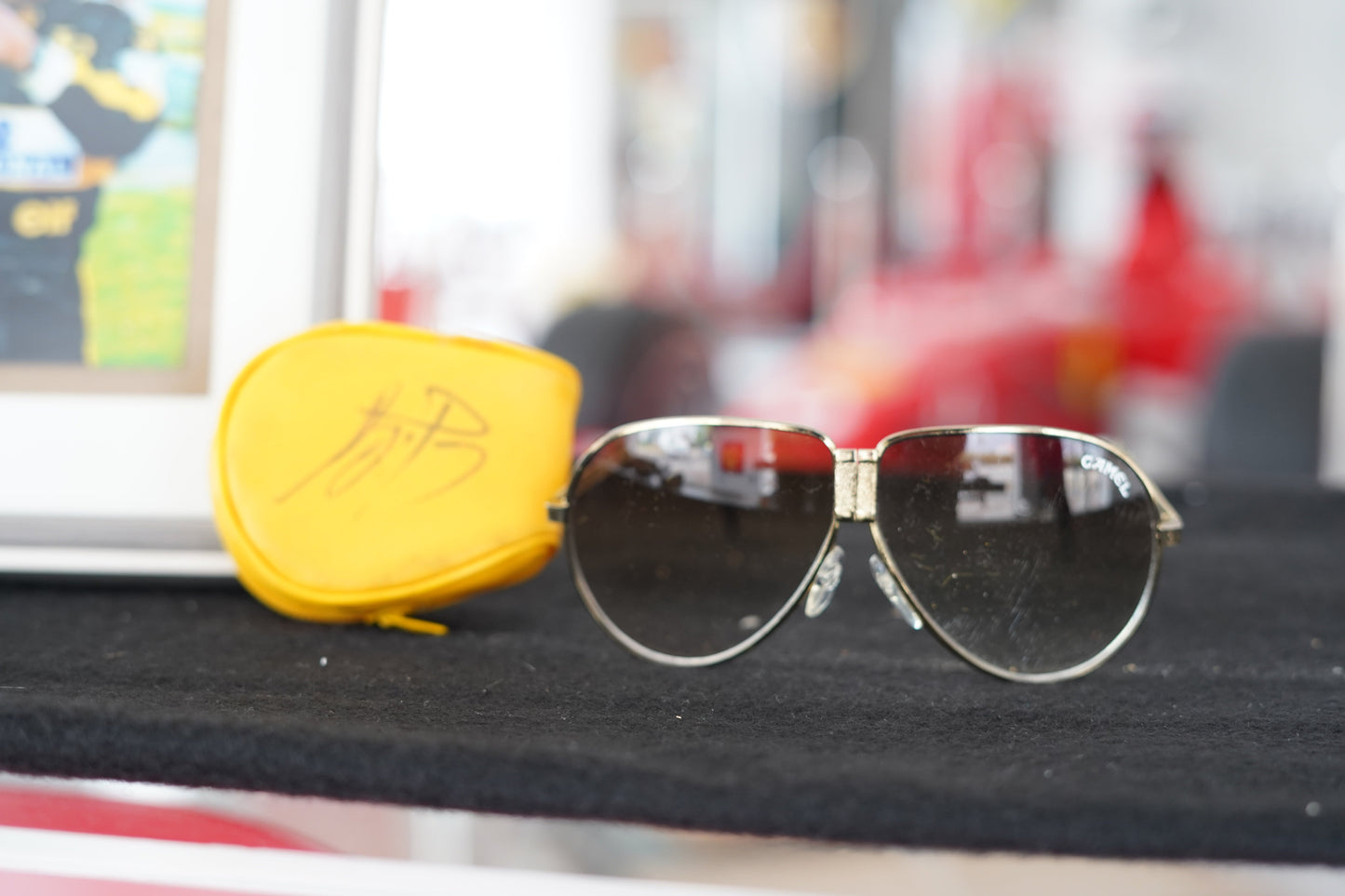 1985 Ayrton Senna personal Camel sunglasses with signed glass holder